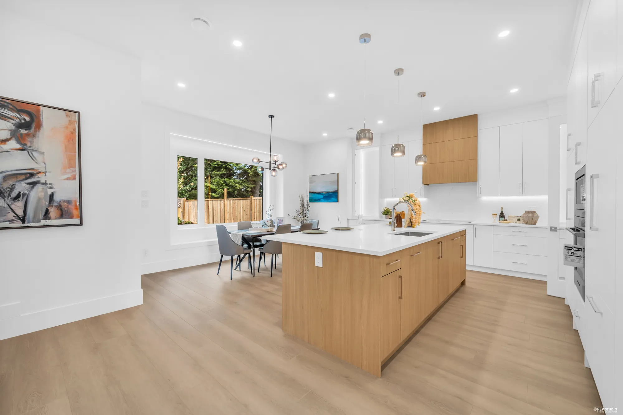The kitchen from the family room end, nook and windows beyond
