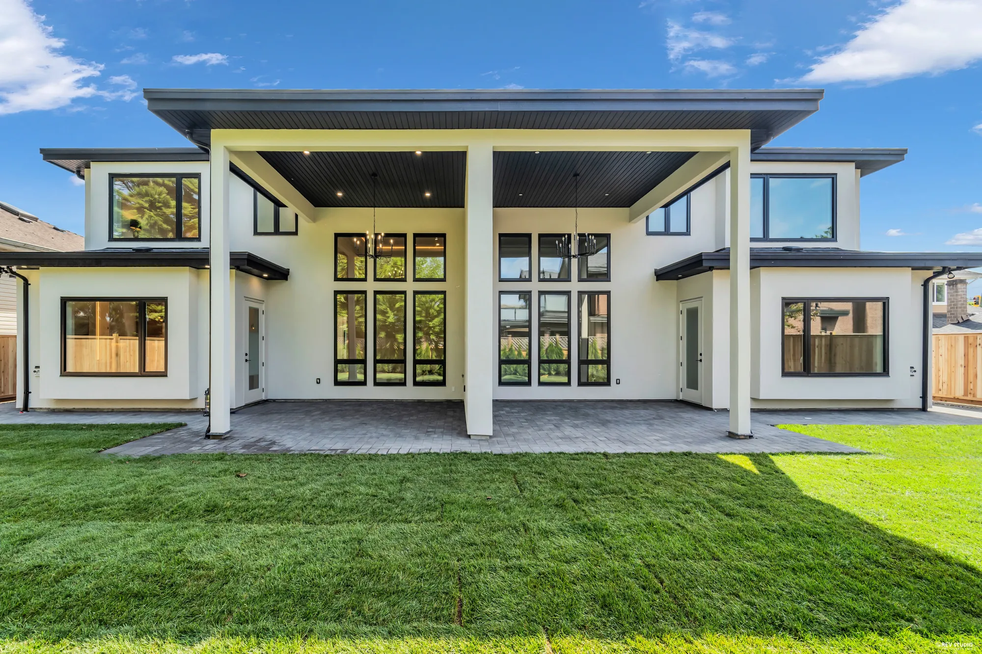 The back elevation of the whole duplex, two covered patios meeting in the middle
