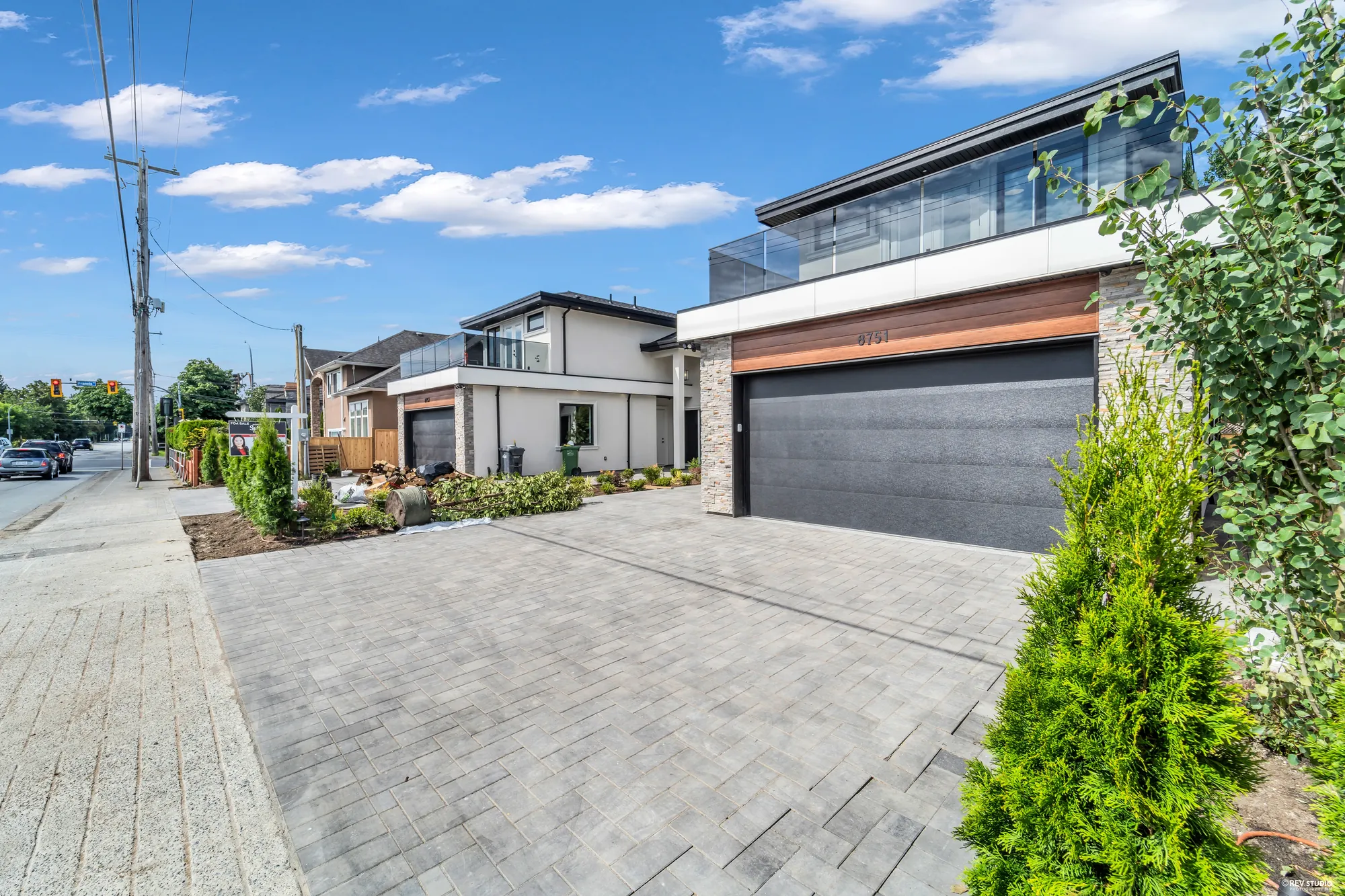 Both halves of the duplex from the shared forecourt, with the street beyond
