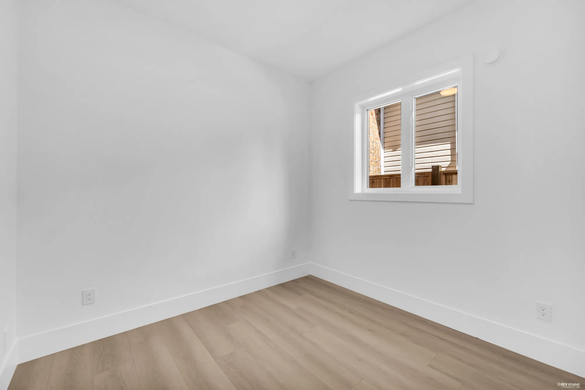 The suite bedroom, unfurnished, with a shuttered window